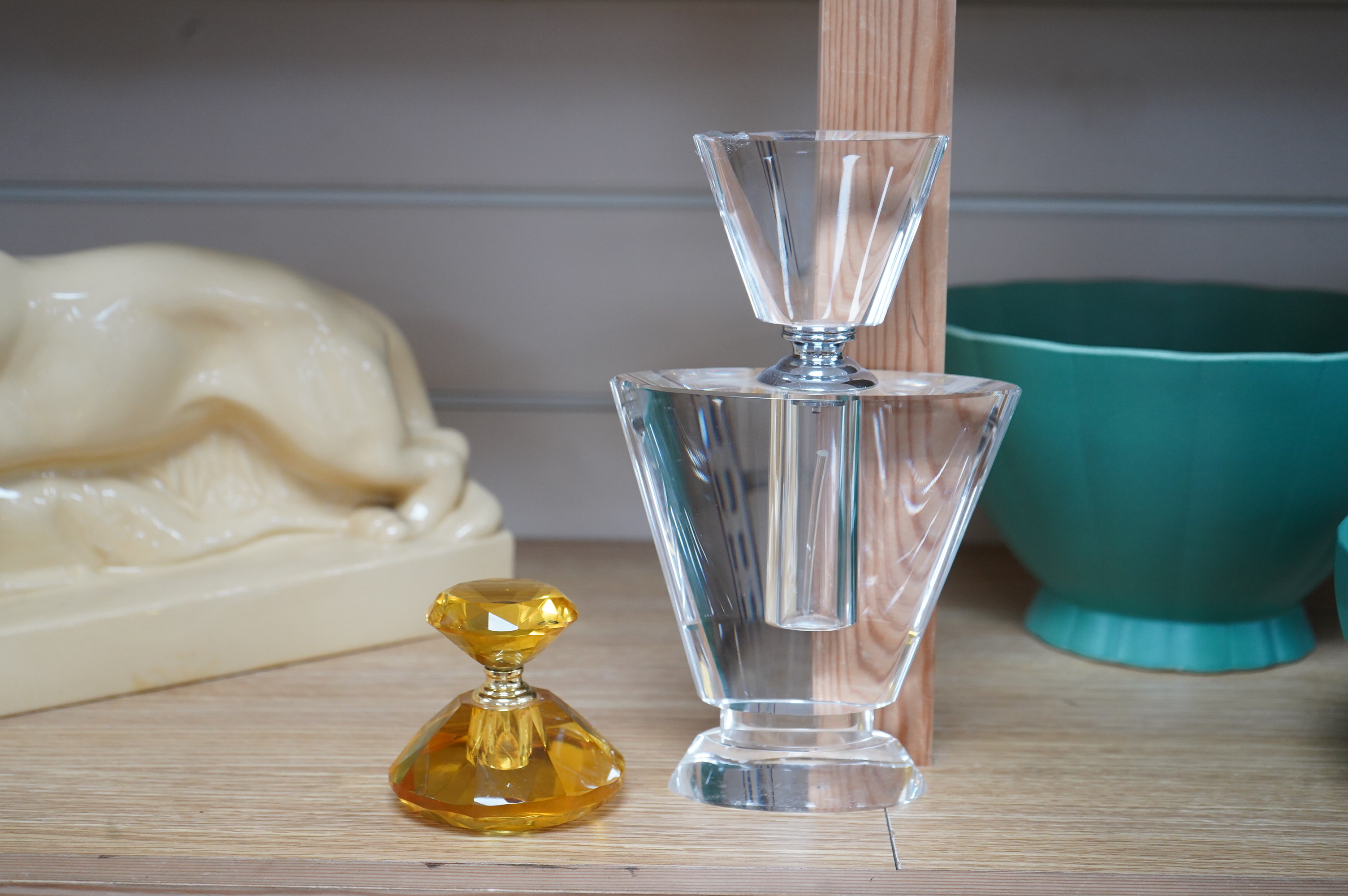 An amber glass perfume bottle and an oversized Art Deco style glass perfume bottle